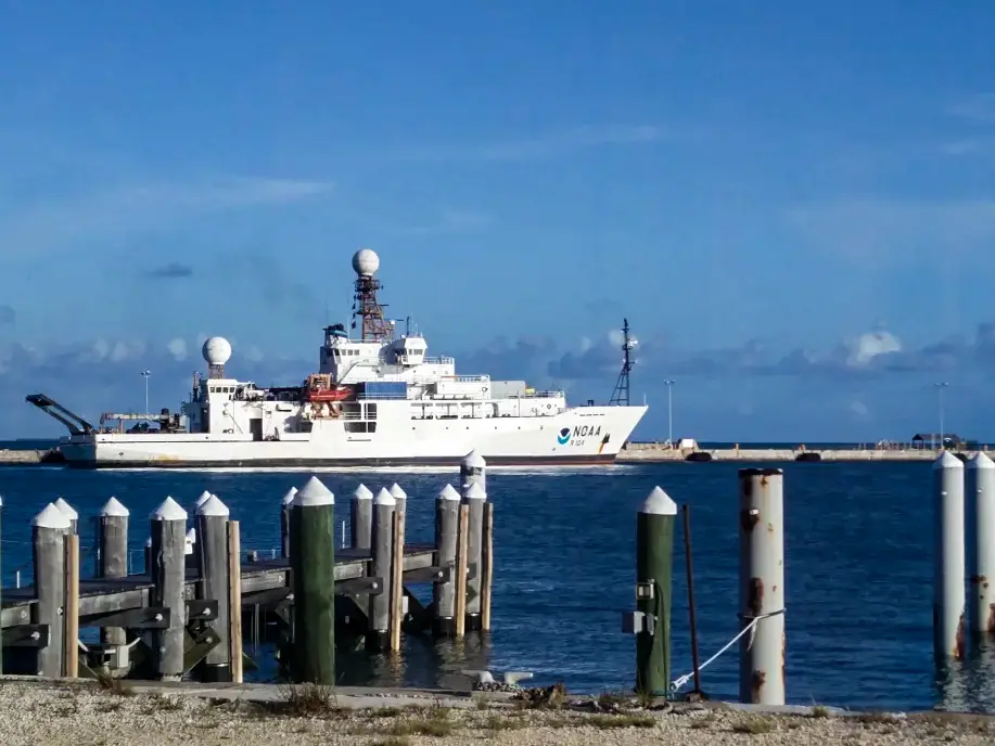 NOAA Ship Ronald H. Brown sailing past a dock